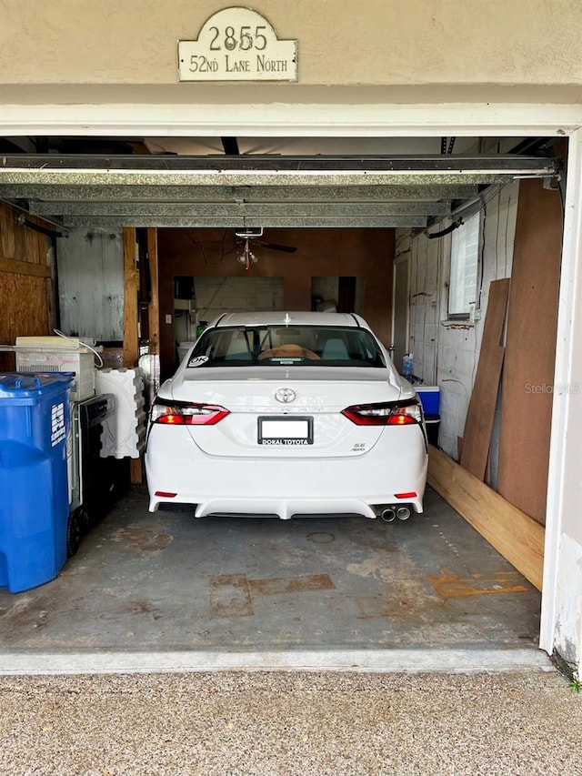 garage featuring wood walls and a garage door opener