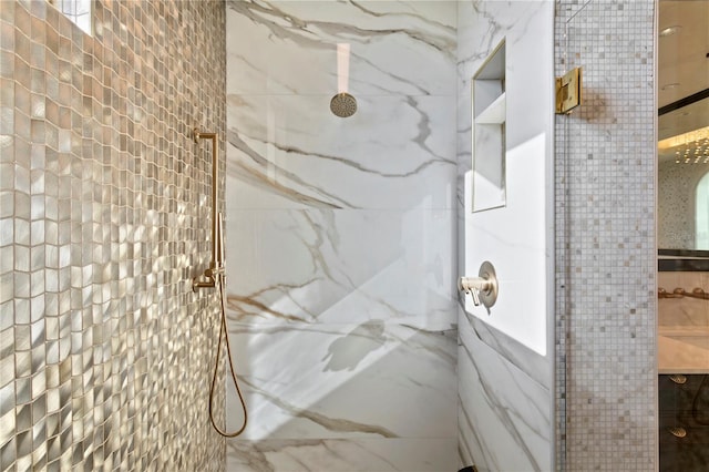 bathroom with tile walls and a shower with shower door