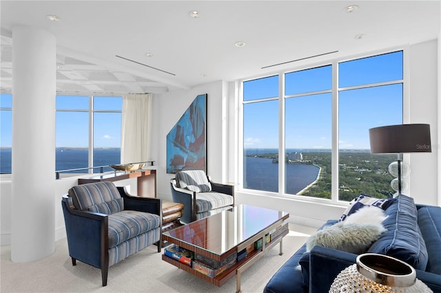 carpeted living room featuring a water view