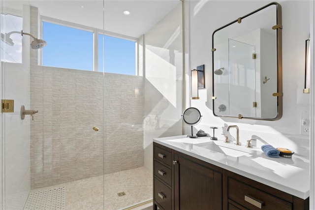 bathroom with vanity and a shower with door