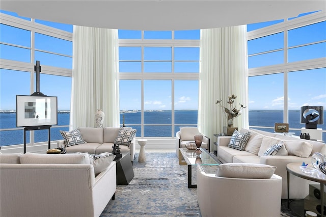 living room featuring a wealth of natural light and a water view