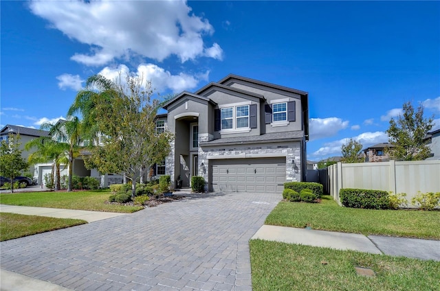 view of front of house with a garage and a front lawn