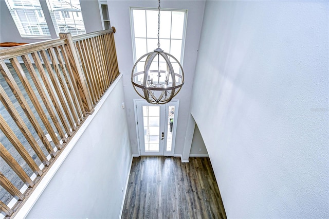 foyer featuring a notable chandelier and dark hardwood / wood-style flooring