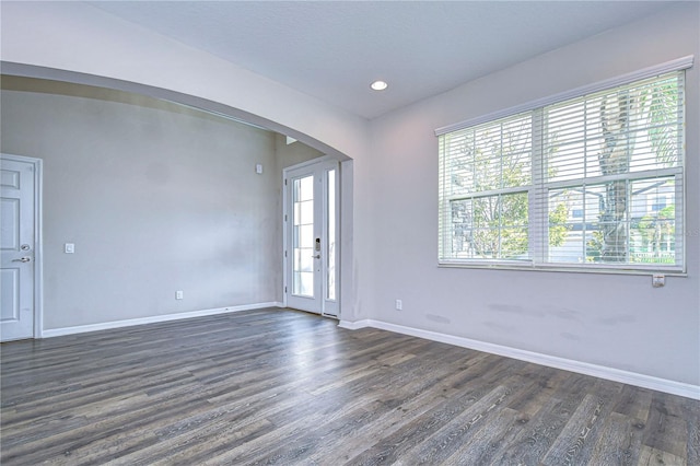 empty room with dark hardwood / wood-style floors