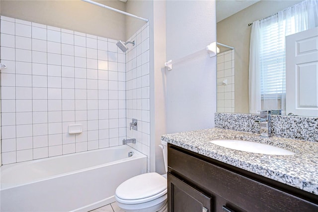 full bathroom featuring toilet, tiled shower / bath combo, and vanity