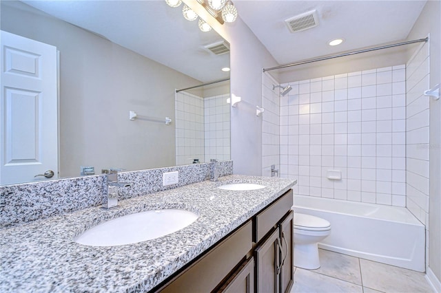 full bathroom with vanity, toilet, tiled shower / bath combo, and tile patterned flooring