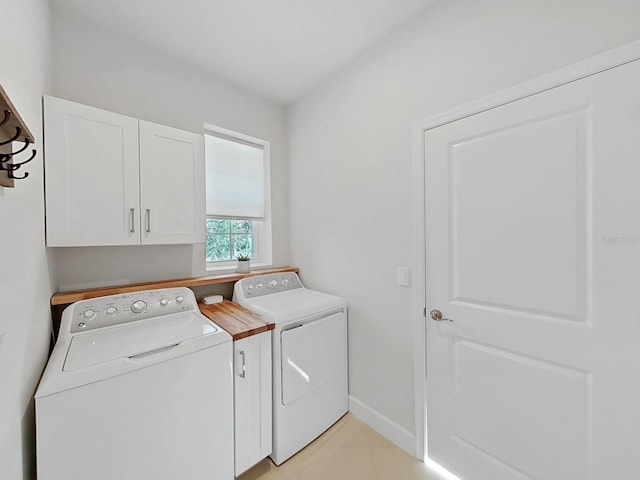 laundry area with washer and clothes dryer and cabinets