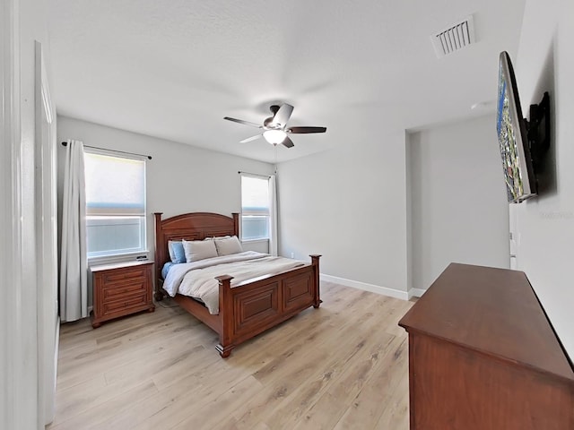 bedroom with ceiling fan and light hardwood / wood-style floors