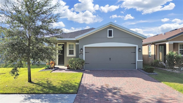 single story home featuring a front lawn and a garage