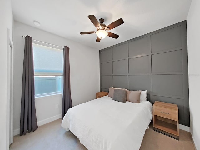 bedroom featuring light colored carpet and ceiling fan