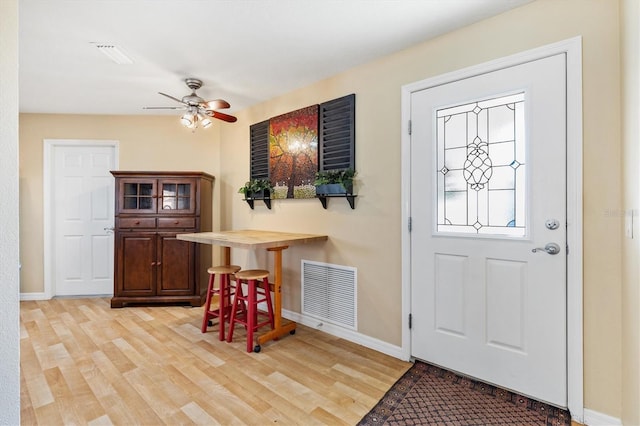 foyer entrance with light wood-type flooring and ceiling fan