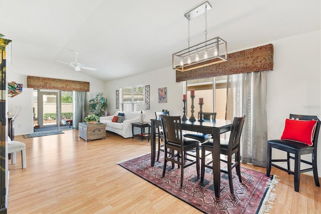 dining room with lofted ceiling, wood-type flooring, and ceiling fan