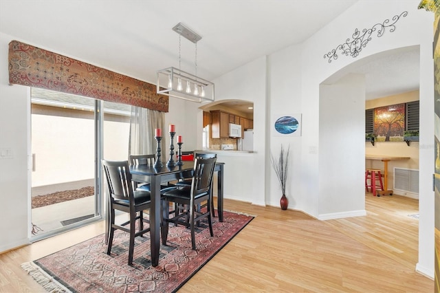 dining area featuring a chandelier and light wood-type flooring