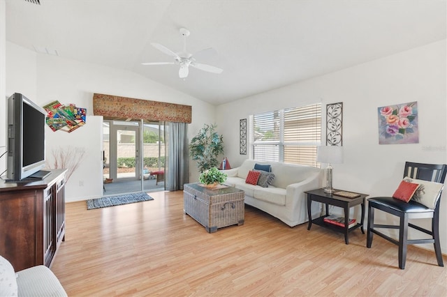 living room featuring light hardwood / wood-style flooring, lofted ceiling, and a wealth of natural light