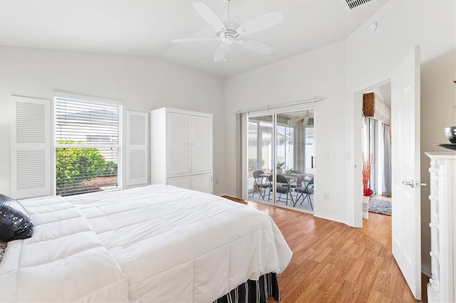 bedroom featuring ceiling fan, access to outside, light hardwood / wood-style flooring, and vaulted ceiling