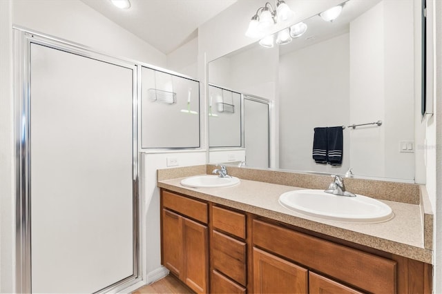 bathroom with vanity, vaulted ceiling, and walk in shower