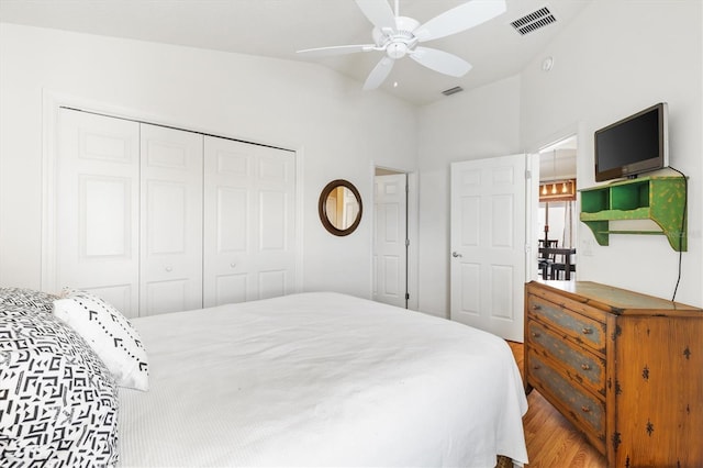 bedroom with a closet, ceiling fan, and light hardwood / wood-style flooring