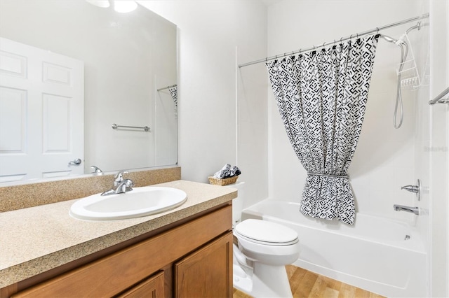 full bathroom featuring vanity, toilet, wood-type flooring, and shower / bath combo