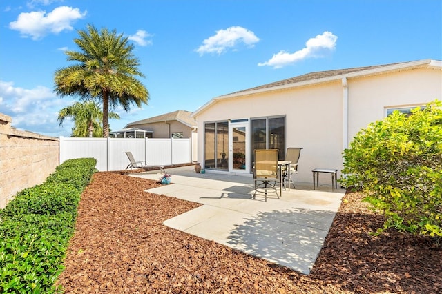 rear view of property featuring a patio