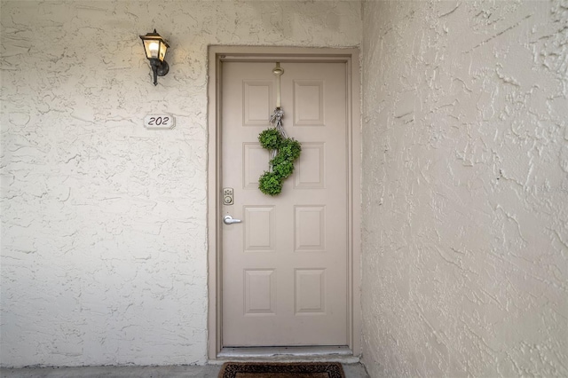 2571 Cyprus Dr Unit 1-202, Palm Harbor, FL 34684 - view of exterior entry with stucco siding