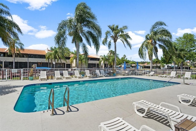 2571 Cyprus Dr Unit 1-202, Palm Harbor, FL 34684 - community pool featuring a patio area and a residential view