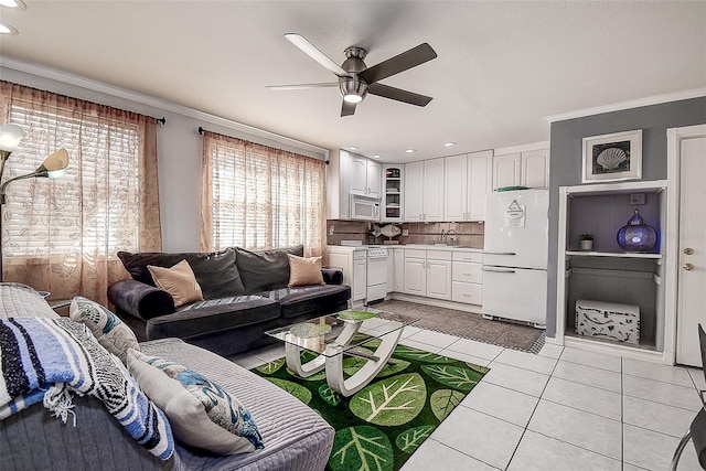 tiled living room featuring ceiling fan and ornamental molding