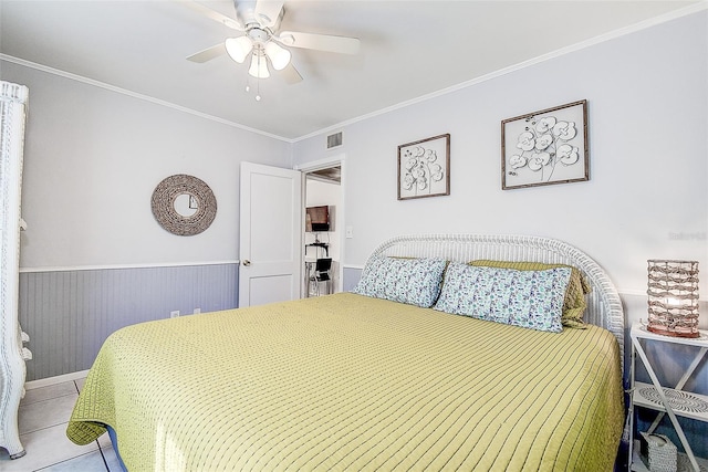 tiled bedroom featuring ornamental molding, wooden walls, and ceiling fan