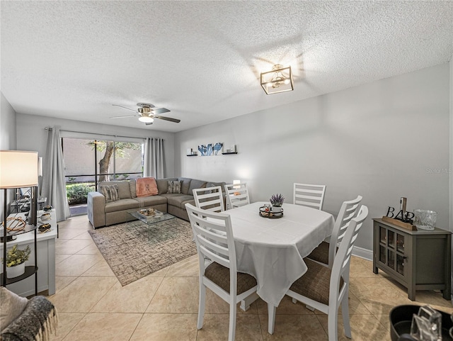 dining room with ceiling fan, a textured ceiling, and light tile patterned floors