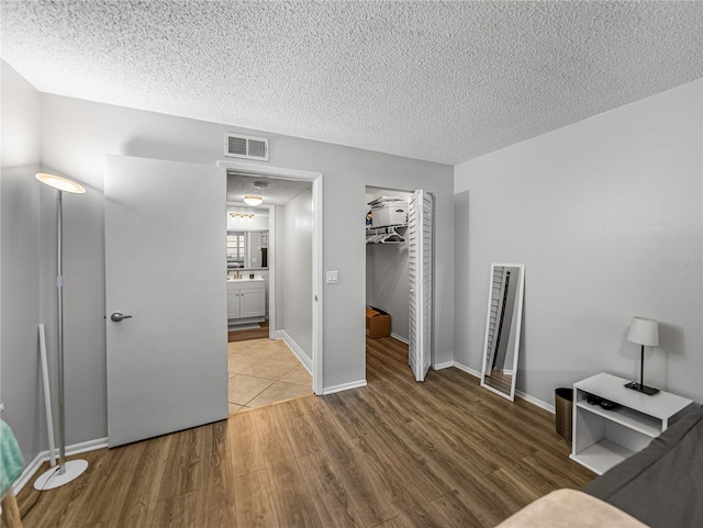 interior space with wood-type flooring and a textured ceiling