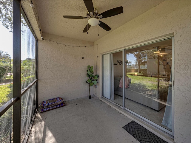 unfurnished sunroom with vaulted ceiling and ceiling fan