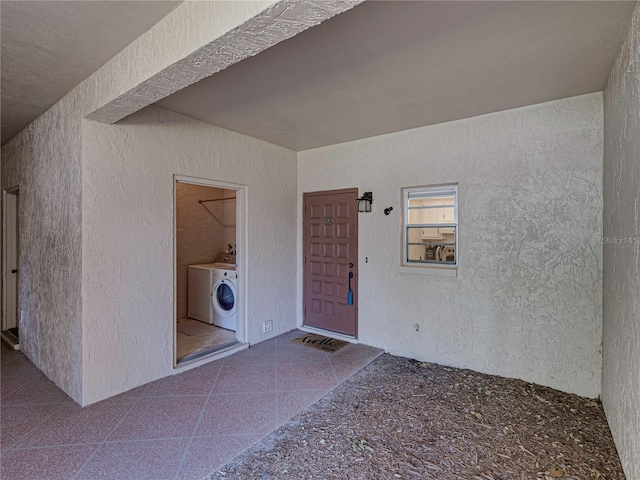 doorway to property featuring washer / clothes dryer