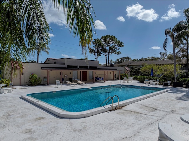 view of swimming pool with a patio