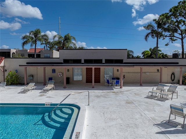 rear view of house with a patio and a community pool