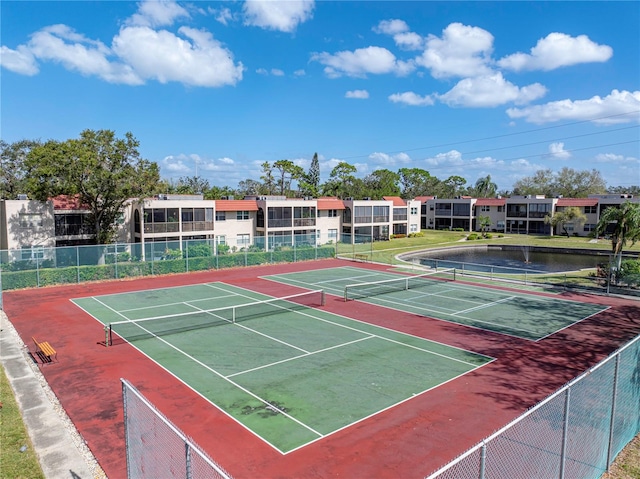 view of sport court featuring a water view