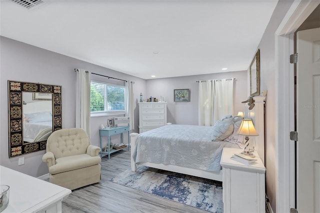 bedroom with hardwood / wood-style floors