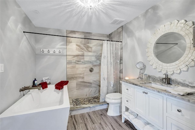 bathroom featuring toilet, hardwood / wood-style floors, a shower with curtain, and vanity