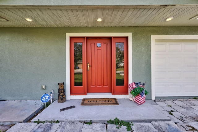 doorway to property featuring a garage