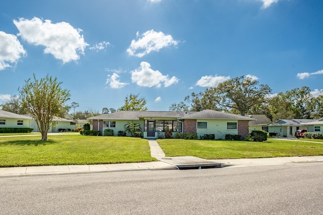 ranch-style home featuring a front lawn