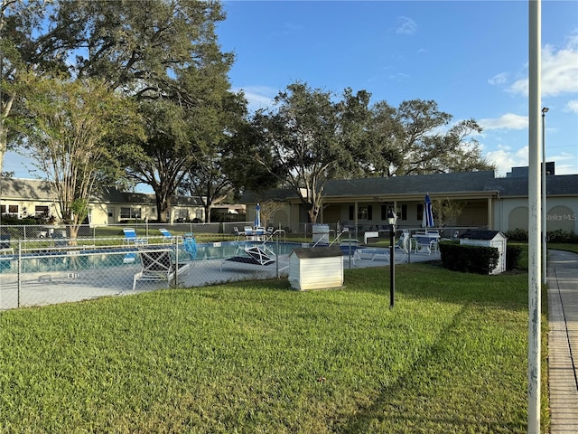 view of yard with a community pool and a patio