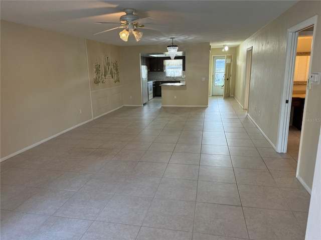 unfurnished living room featuring light tile patterned floors and ceiling fan