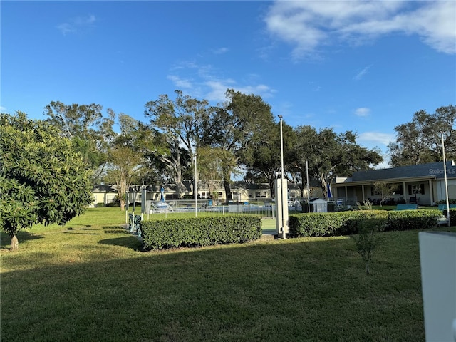 view of home's community with a yard