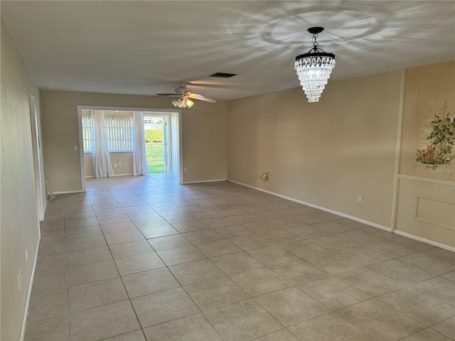 spare room featuring ceiling fan with notable chandelier and light tile patterned flooring