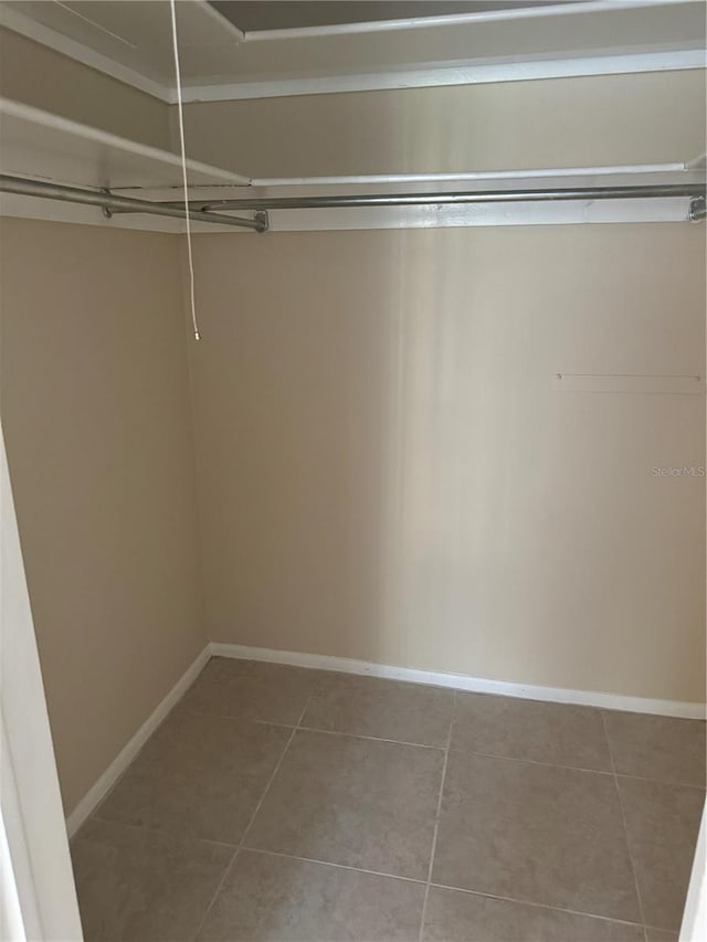 spacious closet featuring tile patterned flooring