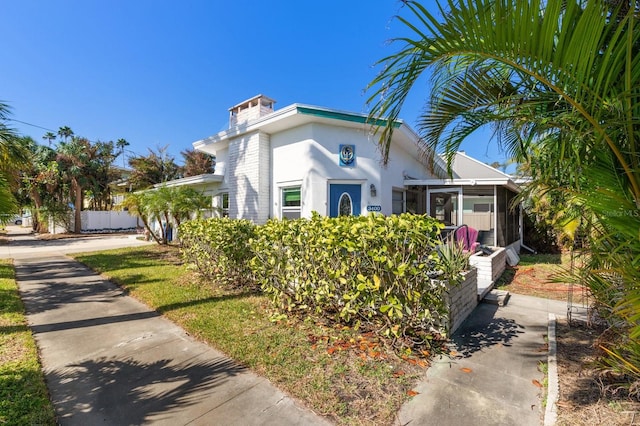 view of front of house with a sunroom