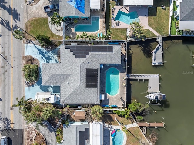 birds eye view of property with a water view