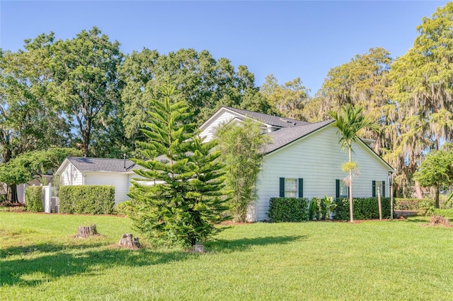 view of side of home with a yard