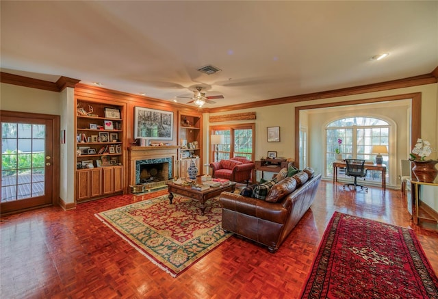 living room with parquet floors, a healthy amount of sunlight, and built in shelves