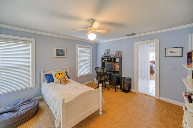 bedroom featuring ceiling fan, ornamental molding, multiple windows, and light colored carpet