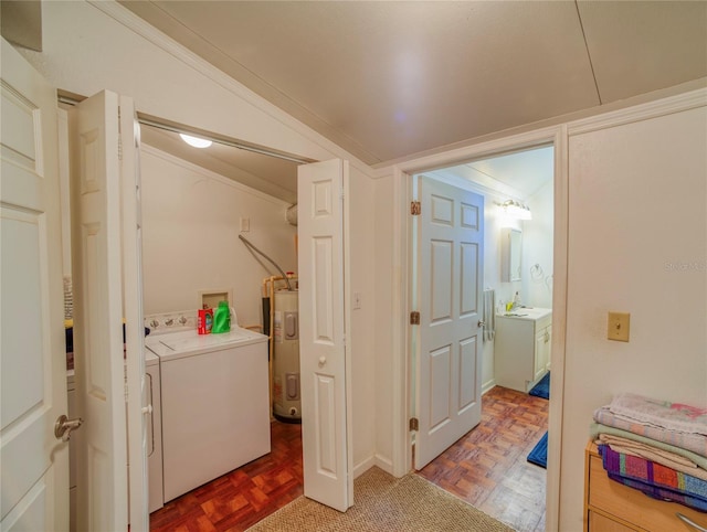 laundry room with parquet floors, ornamental molding, washing machine and dryer, and water heater