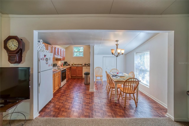 dining room with a chandelier, crown molding, and dark parquet flooring